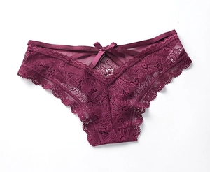 Close-up of elegant burgundy lace panties featuring floral embroidery and a satin bow detail