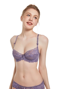 Detail of purple lace bra and matching panties with delicate floral patterns and bow