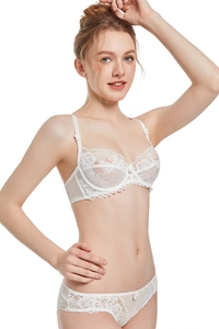 Detail of white floral lace bra set with delicate mesh texture and small bow accents