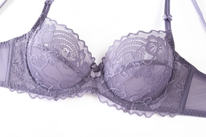Close-up of lilac floral lace embroidery with center bow detail on unlined bra cup