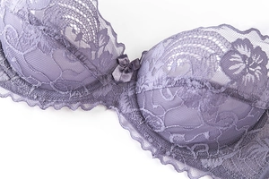 Detail view of mauve floral lace bra with satin bow accent and scalloped mesh edge