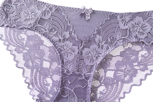 Detail of light purple lace panties with floral pattern and delicate satin bow detail