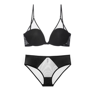 Detail of black and white mesh paneled lingerie set with thin straps and geometric design