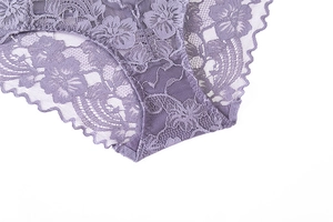 Detailed macro view of purple floral embroidery lace on scallop edge panties