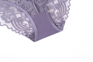 Close-up detail of purple floral lace texture and wavy edges on delicate lingerie