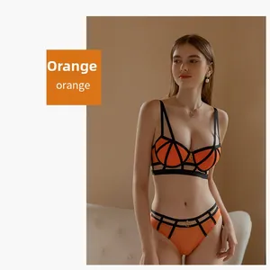 Detail of sexy orange mesh lingerie set with black contrast straps and sheer design