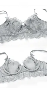 Detail of grey eyelash lace bra featuring semi-circle cup padding and bow decoration