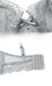 Detail of grey floral lace bra with wide side wings and triple hook-and-eye closure