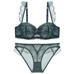 Detailed view of dark green lace lingerie set with ruffled mesh and small bow detail