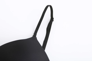 Macro detail of adjustable shoulder strap and seamless black fabric on backless bra