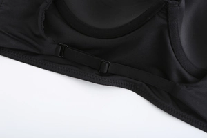 Macro shot of adjustable black straps and scalloped stitching on seamless French bra