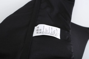 Close-up of the wash label on a black seamless bra showing L size and fabric composition