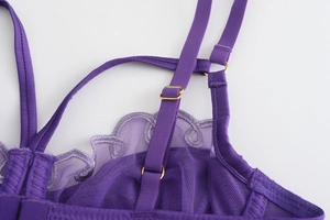 Detail of adjustable straps and purple lace mesh on a sheer French style bra