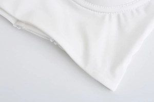 Close-up of seamless white French bra showing fine stitching and smooth elastic fabric