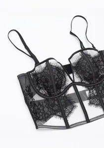 Detail of black eyelash lace bra with fine floral patterns and sheer mesh fabric