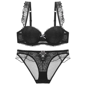 Black lace lingerie set with ruffled straps and white bows on a clean white background