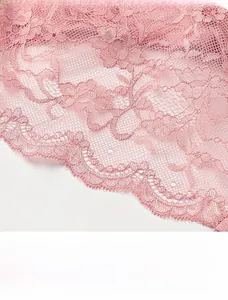 Detailed close-up of pink sheer lace with floral patterns and delicate eyelash edges