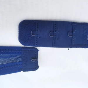 Detailed macro view of the three-level adjustable hook and eye closure on dark blue lace lingerie