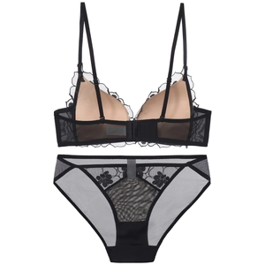 Flat lay view of black lace lingerie set with floral embroidery and mesh texture
