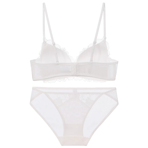 Flat lay of white French lace lingerie set with floral embroidery and mesh details