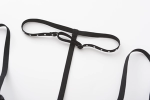 Detail of adjustable black bra strap with silver rhinestones and S-shaped hook fastener