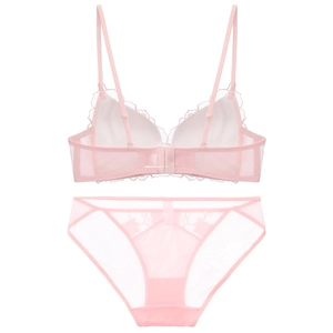 Flat lay of pink lace lingerie set featuring sheer mesh bra and matching floral panties