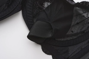Detail of black lace bra interior showing breathable mesh and pad insert slots