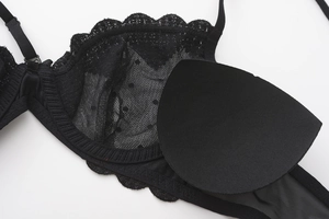 Detail view showing removable padded inserts and lace texture of the black lingerie set