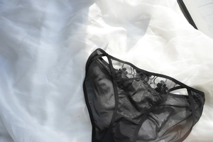 Close-up of black floral lace underwear featuring sheer mesh and intricate embroidery details