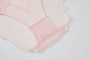 Close-up of pink floral lace fabric and breathable cotton crotch lining for panties