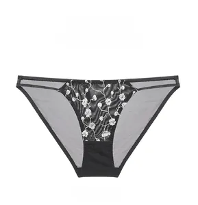 Vue à plat de culottes en maille noire avec des détails de broderies florales blanches