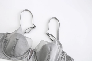 Detail of grey mesh lace bra showing fine stitching and adjustable thin shoulder straps