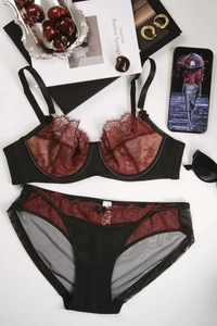 Flat lay of elegant black and burgundy lace lingerie set with stylish lifestyle props