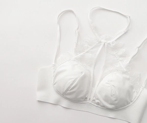 Close-up of white eyelash lace detailing on a French style halter neck bra