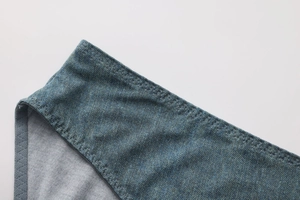 Macro detail of seamless denim print fabric with zigzag stitching on low waist panties