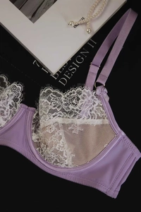 Detail of lavender French lace bra with eyelash lace trim and silk satin side wings