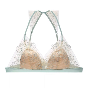 Detail of mint green triangle cup bra with floral embroidery and sheer mesh overlay