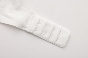 Detailed macro view of white lace bra back closure with four-row two-button hooks