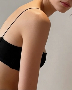 Detail showing thin straps and smooth black fabric of a seamless wire-free bra set