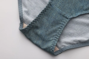 Macro shot of cotton crotch detail with denim print and scalloped elastic edges
