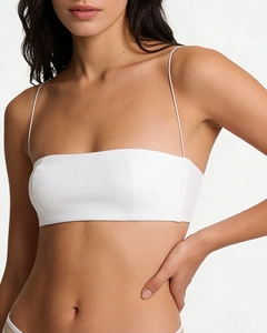Close-up of minimalist white seamless bra with ultra-thin shoulder straps on model