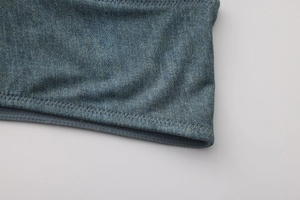 Detailed macro view of the blue elastic fabric texture with precision zigzag stitching