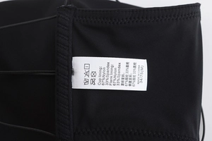Detail of fabric label showing 67% nylon and 33% spandex blend on black lingerie
