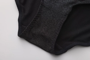 Detailed view of women's black glitter underwear featuring silver shimmer and fine stitching