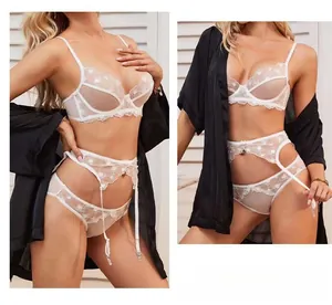 Details eines weißen Spitzen-BH-Sets mit Herzstickerei und passenden Strapshaltern