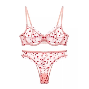 Pink sheer mesh lingerie set with red heart embroidery and ruffled bra detailing