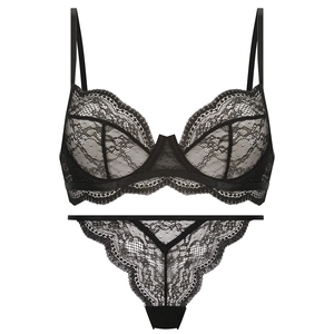 Flat lay of black floral lace lingerie set with underwire bra and matching thong