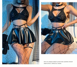 Detailed view of sexy black PU leather pleated mini skirt and buckle top set with fishnet socks