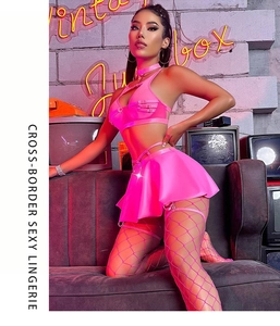 Detail of neon pink lace lingerie set with halter top and pleated skirt on a model
