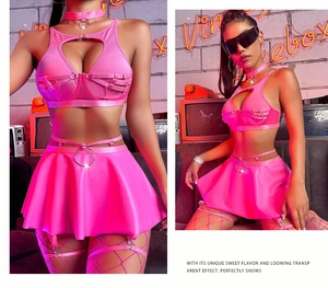 Pink metallic lingerie set with lace-up detail, mini skirt, and silver ring accents